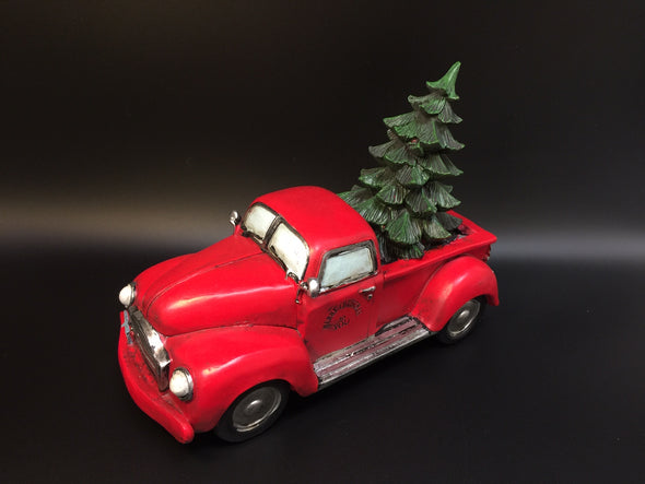 RED PICK UP TRUCK WITH CHRISTMAS TREE IN BED