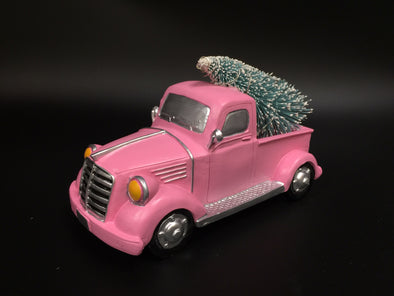 PINK PICK UP TRUCK W/ CHRISTMAS TREE IN BACK