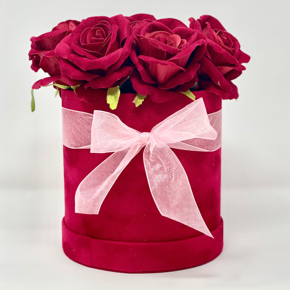 RED ROSES IN RED VELVET CIRCLE BOX WITH PINK BOW